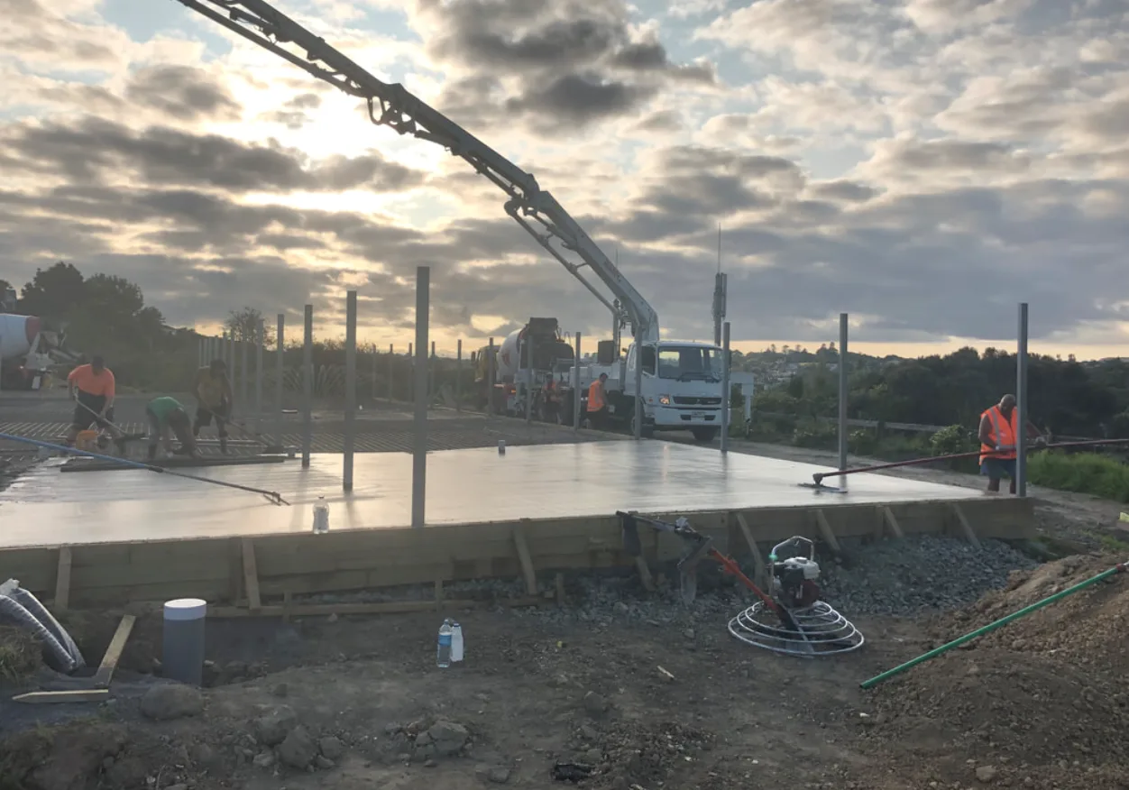 Concrete pump truck pouring a house foundation slab