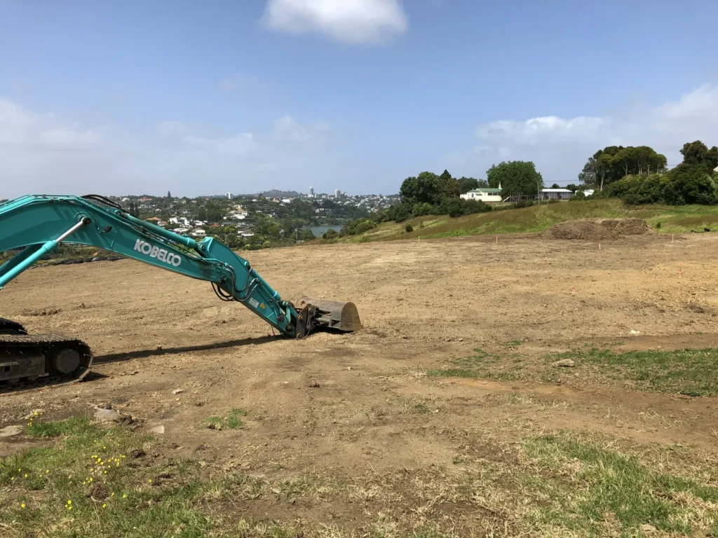 Excavator levelling a large rural building site