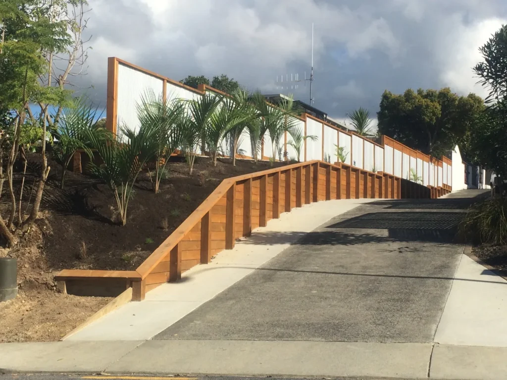 Timber retaining wall and concrete steps built into a landscaped bank